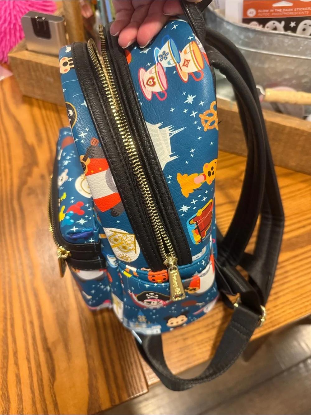 Loungefly Blue Mini Backpack with Colorful Theme Park Character Print